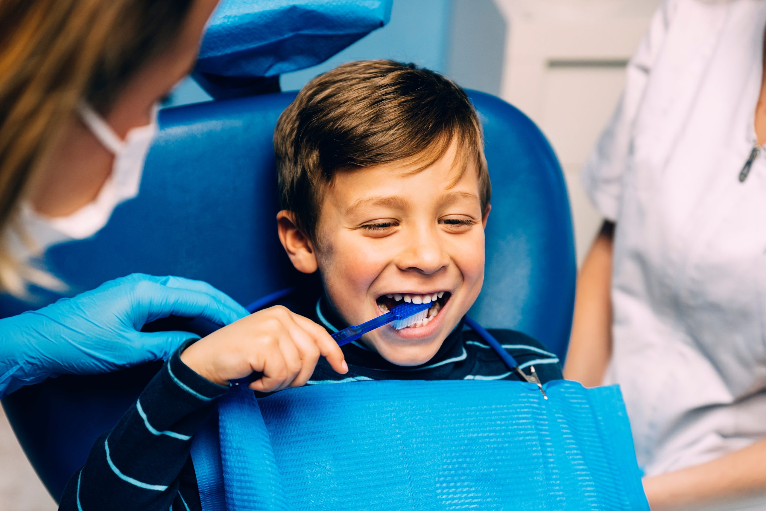 kid at scholes family dental smiling after a cleaning