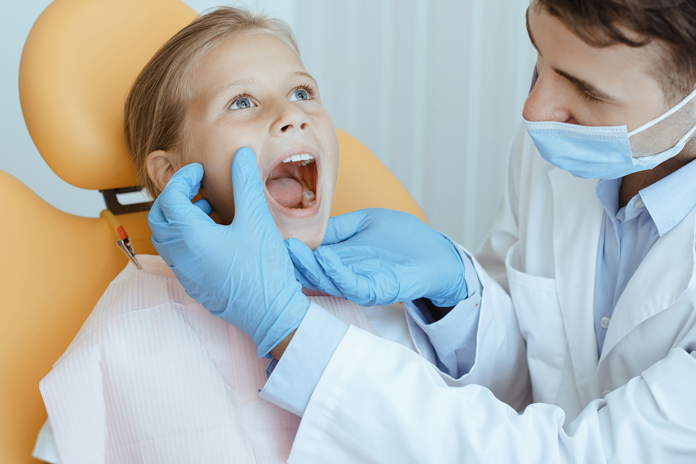Girl getting an oral exam at the dentist in Coeur d'Alene, ID